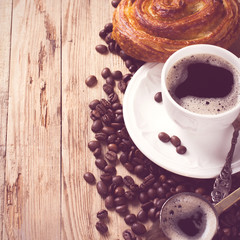 Old coffee pot and cup on wooden rustic background