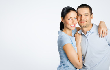 Cheerful young lovely couple, with copyspace
