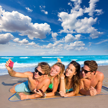 Selfie group of tourist friends in a tropical beach