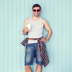 Portrait of funny smiling hipster man in red heart shaped