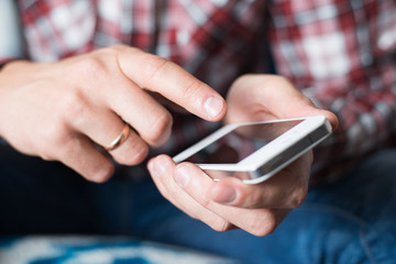 Close up of a man using mobile smart phone