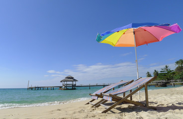 two chairs on a paradise beach and parasol