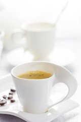 Cup of coffee on white wooden background