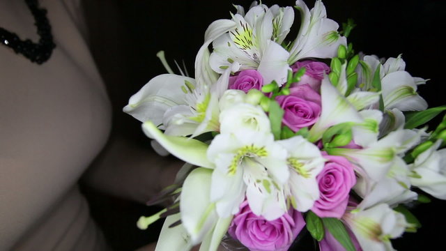 wedding bouquet with white lilies and pink roses turns around	