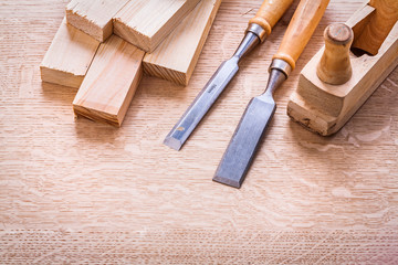 chisels  plane planks on wooden board