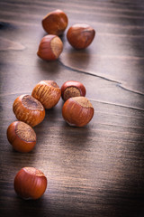 vertical view hazelnuts on  vintage  wooden board food and drink