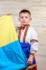 Cute child holding the national flag of Ukraine