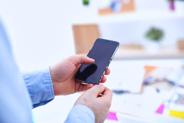 Businessman using mobile phone at modern stylish office