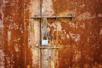 Rusty metal door with lock