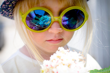 Cute little girl wearing mirrored round sunglasses