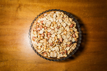 peanuts in bowl on vintage background