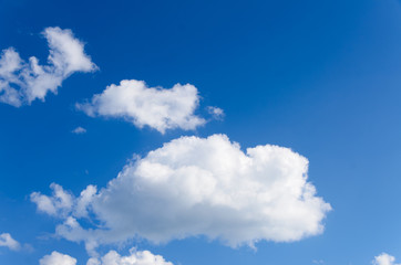 Fototapeta na wymiar White Puffy Clouds in Blue Sky