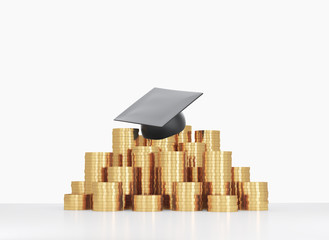 Graduation hat is laying on the coins pyramid. 