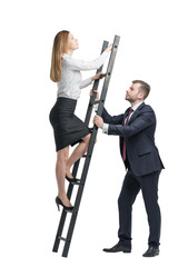 handsome businessman is holding a ladder 