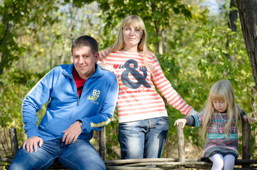 Small Family Taking a Pose at the Garden Fence