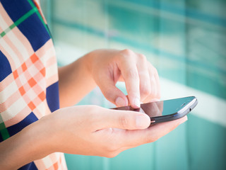 Close up woman hand typing on smart phone