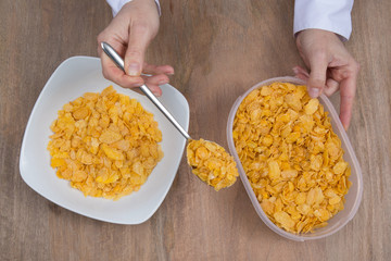 Cornflakes in porcelain bowl isolated on white background
