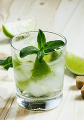 Fresh cocktail witn soda, lemon and mint, selective focus