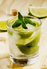 Fresh cocktail witn soda, lemon and mint, selective focus