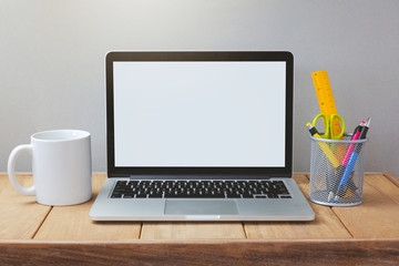 Laptop with white screen mock up office desk template.