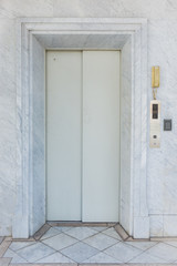 Obraz na płótnie Canvas Elevator door with marble wall