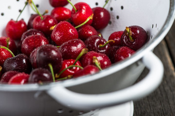 Fresh clean organic ripe cherries in colander