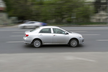 Plakat car in motion with blurred background.