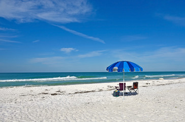 Fototapeta na wymiar Beach Chairs with Umbrella
