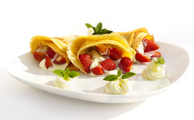 pancake with strawsberries, whipped cream and  mint