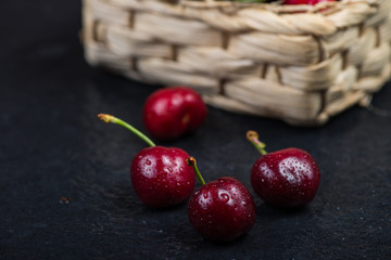 Fresh ripe organic cherries on black border  background