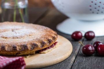 Homemade cherry pie served on rustic table