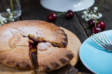 traditional homemade cherry pie served on rustic table