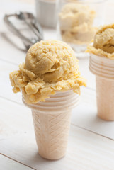 Homemade mango ice cream on vintage light white wooden