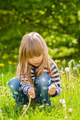 Beautiful little blonde girl, playing outdoor, springtime © Tomsickova