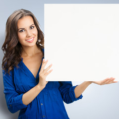 Young happy smiling woman with blank signboard