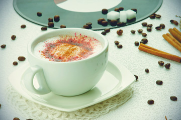 Cappuccino coffee, coffee beans and sugar cubes