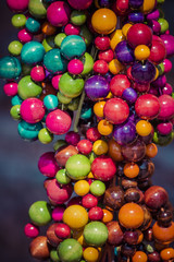 Beads of round colorful stones lie on the counter of souvenir sh