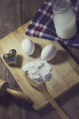Flour and eggs on a wooden table