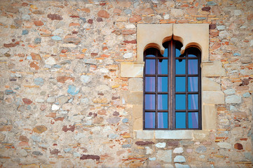 Stone wall with a decorated window, European castle