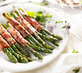 Grilled green asparagus wrapped in bacon