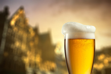 Glass of beer against blurred european city