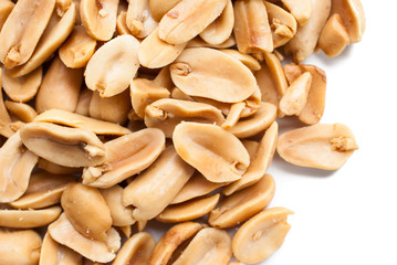 Peanuts. Close up of fried, peeled and salted peanuts on white b