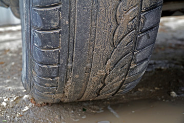 Fototapeta na wymiar Dirty wheel of the car 