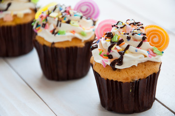 Fototapeta na wymiar Gourmet cupcakes with white buttercream frosting and sprinkles