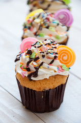 Gourmet cupcakes with white buttercream frosting and sprinkles o