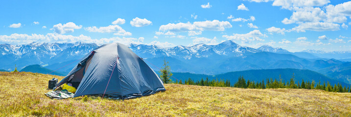 Panoramic view of tourist tent and a mountain range - 83424799
