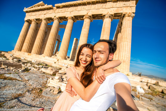 Young couple taking selfie picture with Parthenon temple on