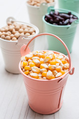 Bulk of corn grain on wooden table, macrobiotic food or healthy