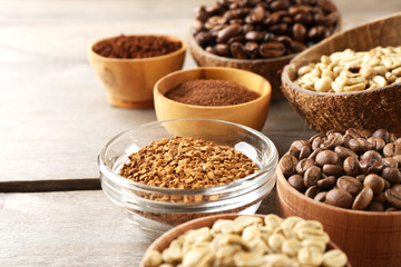 Various of coffee in small dishes on wooden background