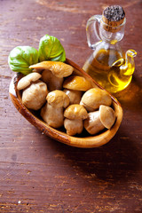  pickled white mushrooms in wooden bowl on vintage wood with bas